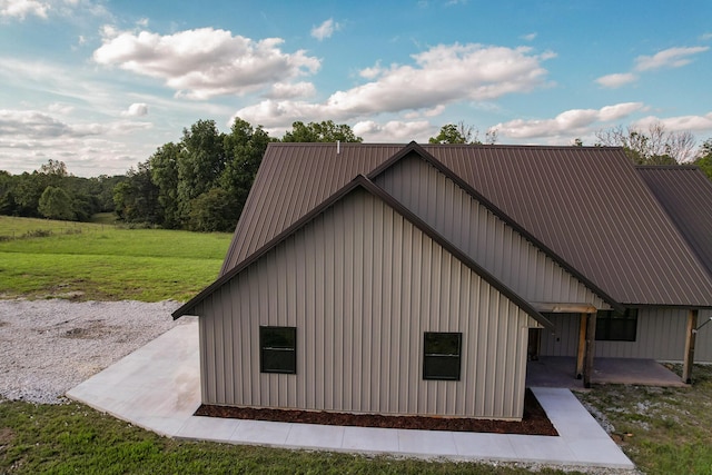 19040 Norway Rd, Neosho, MO 64850 - view of property exterior featuring a lawn, board and batten siding, and metal roof