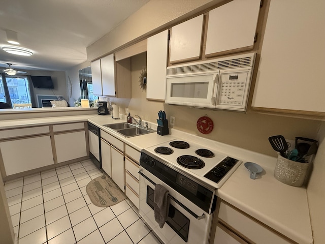 132 Highland Dr Unit 2, Branson, MO 65616 - kitchen with white appliances, a sink, light tile patterned floors, light countertops, and white cabinets