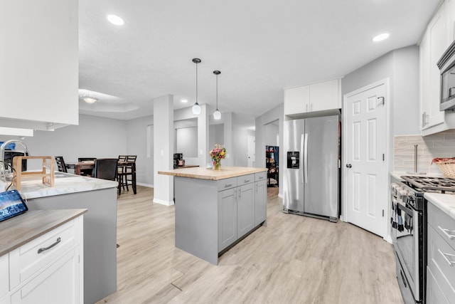 1108 E Robin St, Ozark, MO 65721 - kitchen featuring stainless steel appliances, light wood-style flooring, a kitchen island, recessed lighting, and gray cabinetry