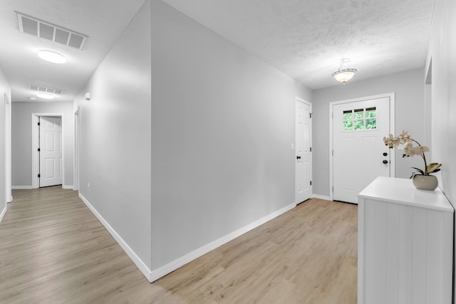 1108 E Robin St, Ozark, MO 65721 - foyer featuring light wood-type flooring, baseboards, and a textured ceiling