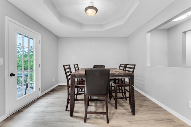 1108 E Robin St, Ozark, MO 65721 - dining space with wood finished floors, a raised ceiling, and baseboards