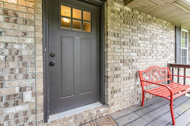 1108 E Robin St, Ozark, MO 65721 - view of exterior entry with brick siding and a porch