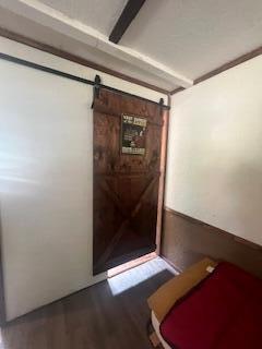 20001 Clear Lake Ter, Winona, MO 65588 - corridor featuring a barn door and wood finished floors