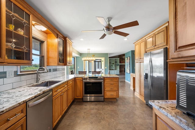 6 Cedar Ln, Kimberling City, MO 65686 - kitchen featuring appliances with stainless steel finishes, a sink, a peninsula, ceiling fan, and tasteful backsplash