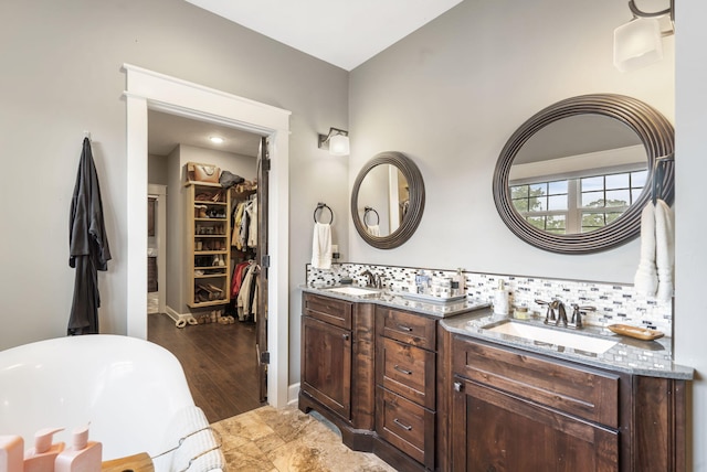 403 S 3rd St, Ozark, MO 65721 - bathroom with double vanity, a soaking tub, backsplash, and a walk in closet