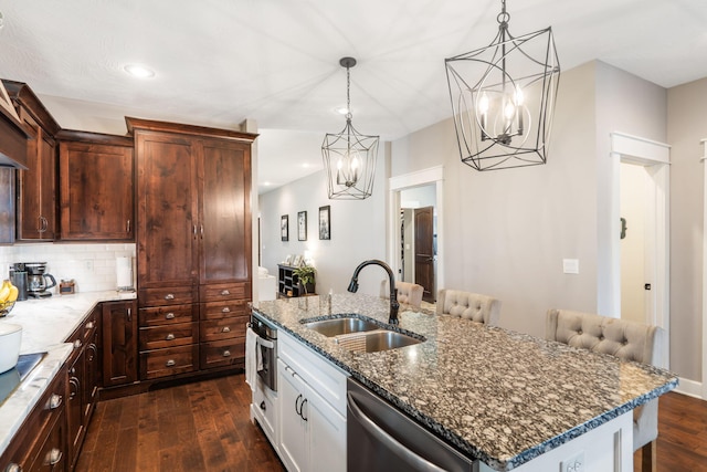403 S 3rd St, Ozark, MO 65721 - kitchen with a sink, a chandelier, stainless steel dishwasher, dark wood-style flooring, and dark stone counters