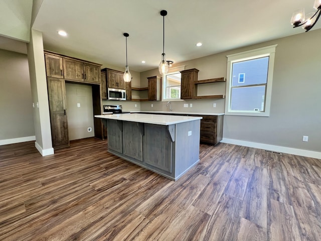 409 Silverwood Cir, Branson West, MO 65737 - kitchen with stainless steel appliances, open shelves, a center island, baseboards, and dark wood-style flooring