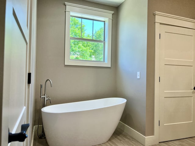 409 Silverwood Cir, Branson West, MO 65737 - full bathroom with plenty of natural light, a freestanding bath, and baseboards