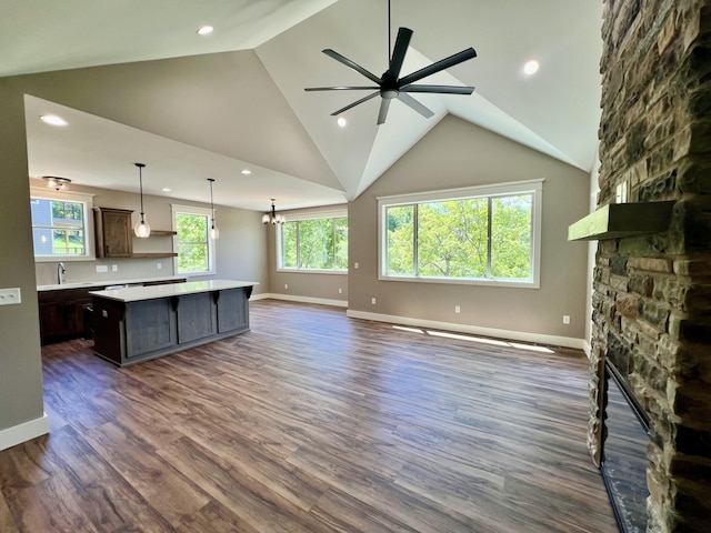 409 Silverwood Cir, Branson West, MO 65737 - unfurnished living room with a stone fireplace, a sink, lofted ceiling, a ceiling fan, and dark wood finished floors