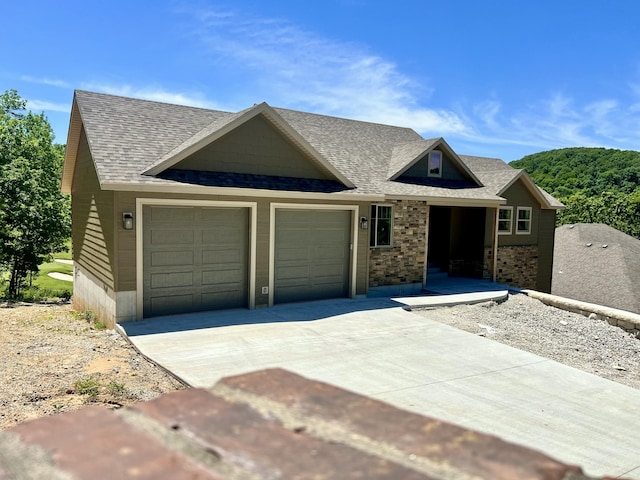 409 Silverwood Cir, Branson West, MO 65737 - view of front of property with an attached garage, driveway, and a shingled roof