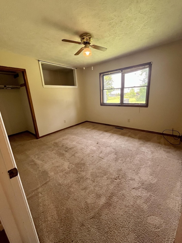 194 State Highway T, Oldfield, MO 65720 - unfurnished bedroom with a textured ceiling, baseboards, carpet, and ceiling fan