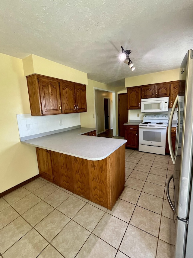 194 State Highway T, Oldfield, MO 65720 - kitchen featuring white appliances, a peninsula, light tile patterned flooring, a textured ceiling, and light countertops