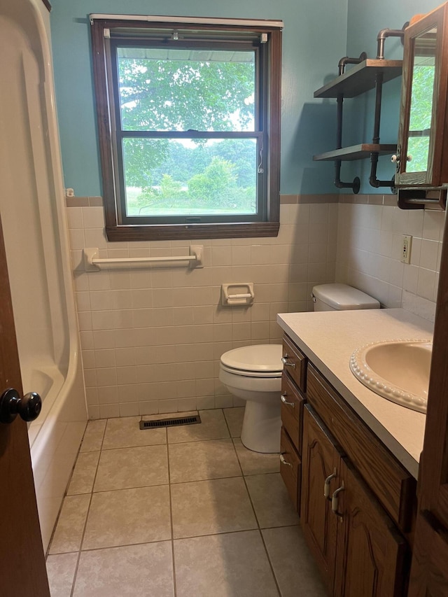 194 State Highway T, Oldfield, MO 65720 - full bath with tile walls, toilet, tile patterned floors, vanity, and a wainscoted wall