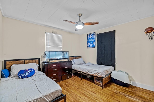 1103 4th St, Monett, MO 65708 - bedroom with light wood-type flooring and ceiling fan