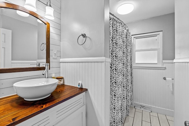 1103 4th St, Monett, MO 65708 - bathroom with wainscoting, vanity, and a shower with curtain