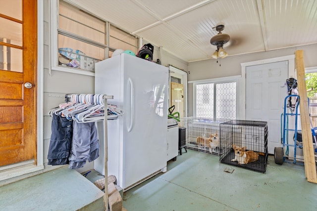 1103 4th St, Monett, MO 65708 - kitchen featuring freestanding refrigerator, finished concrete flooring, and a ceiling fan