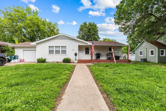 1103 4th St, Monett, MO 65708 - view of front of property featuring a garage, a front lawn, cooling unit, and crawl space