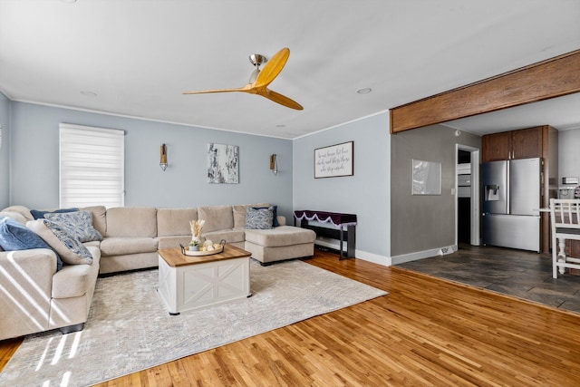 1103 4th St, Monett, MO 65708 - living area featuring a ceiling fan, wood finished floors, and baseboards