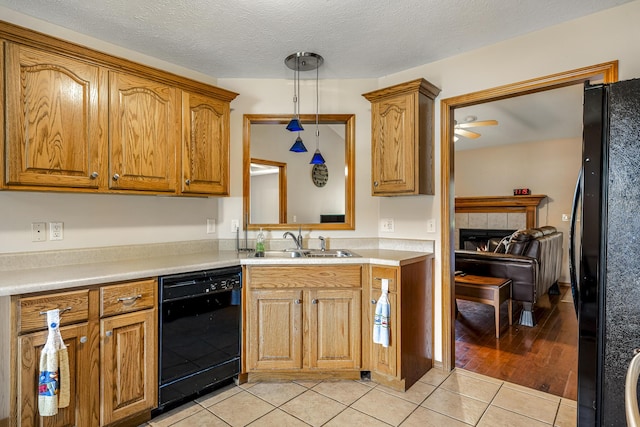 849 S Mahn Ave, Springfield, MO 65802 - kitchen featuring black appliances, a sink, light tile patterned floors, ceiling fan, and hanging light fixtures