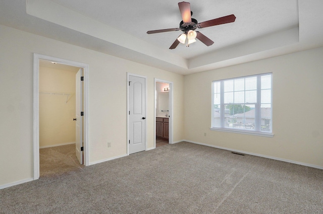 612-614 E Daniels St, Ozark, MO 65721 - unfurnished bedroom with a raised ceiling, a walk in closet, carpet, and baseboards
