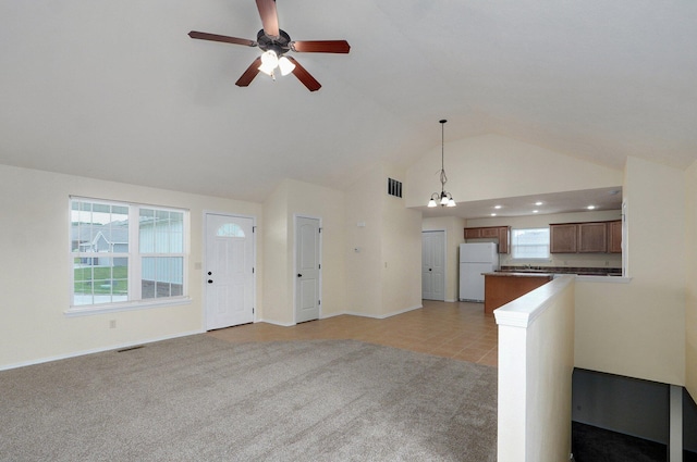 612-614 E Daniels St, Ozark, MO 65721 - unfurnished living room featuring ceiling fan, baseboards, a chandelier, high vaulted ceiling, and light colored carpet