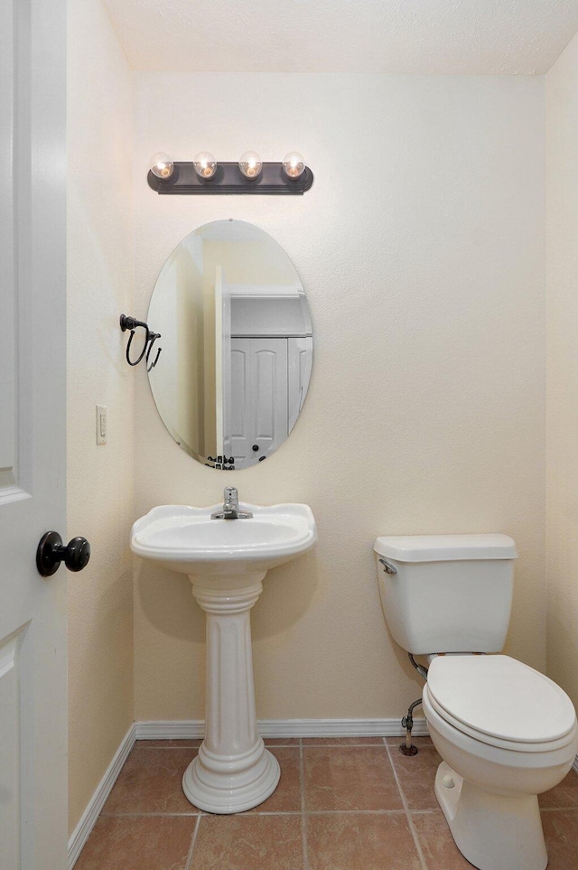 612-614 E Daniels St, Ozark, MO 65721 - bathroom featuring baseboards, toilet, and tile patterned floors