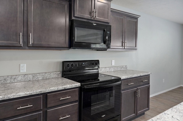 1366 S Olde Savannah Ave, Republic, MO 65738 - kitchen featuring black appliances, dark brown cabinetry, light countertops, light wood-type flooring, and baseboards