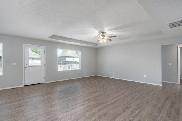 1366 S Olde Savannah Ave, Republic, MO 65738 - unfurnished living room with a raised ceiling, a ceiling fan, wood finished floors, a textured ceiling, and baseboards