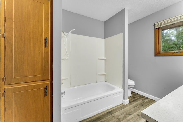1061 Brentwood Dr, Marshfield, MO 65706 - full bath with wood finished floors, toilet, shower / tub combination, baseboards, and vanity