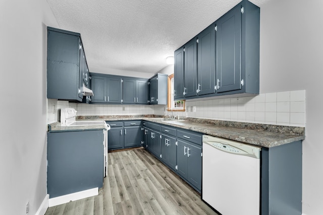 1061 Brentwood Dr, Marshfield, MO 65706 - kitchen featuring white dishwasher, light wood finished floors, stove, backsplash, and a textured ceiling