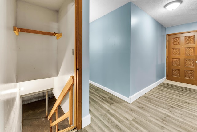 1061 Brentwood Dr, Marshfield, MO 65706 - corridor featuring wood finished floors, baseboards, and a textured ceiling