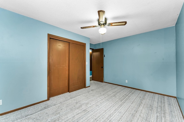 1061 Brentwood Dr, Marshfield, MO 65706 - unfurnished bedroom featuring a closet, baseboards, carpet, a ceiling fan, and a textured ceiling