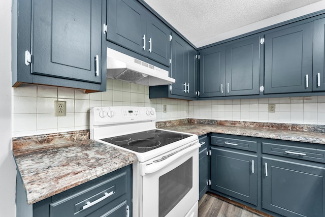 1061 Brentwood Dr, Marshfield, MO 65706 - kitchen with electric range, under cabinet range hood, backsplash, dark wood-type flooring, and blue cabinetry
