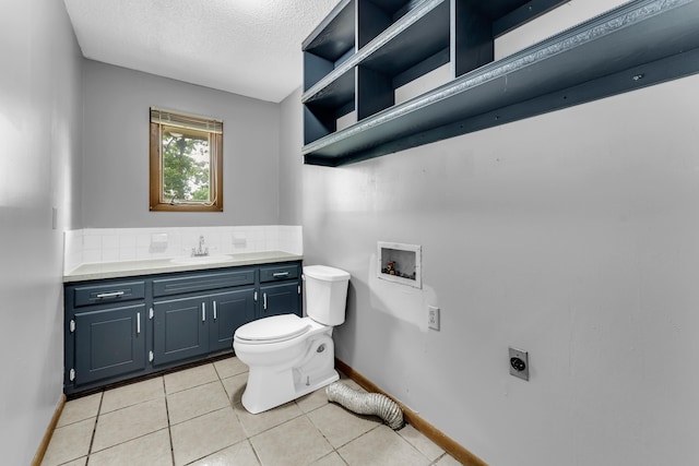 1061 Brentwood Dr, Marshfield, MO 65706 - bathroom with toilet, vanity, baseboards, tile patterned flooring, and a textured ceiling