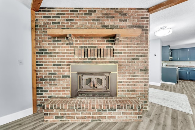 1061 Brentwood Dr, Marshfield, MO 65706 - detailed view of wood finished floors, baseboards, a textured ceiling, and backsplash