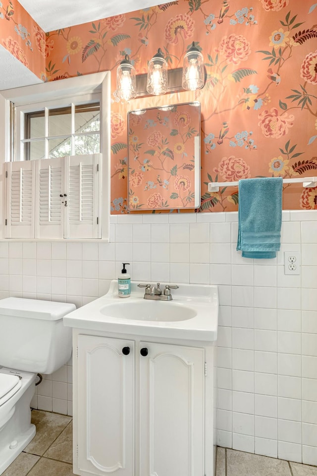 2215 E Rosebrier St, Springfield, MO 65804 - half bathroom with tile walls, vanity, wallpapered walls, a wainscoted wall, and tile patterned floors