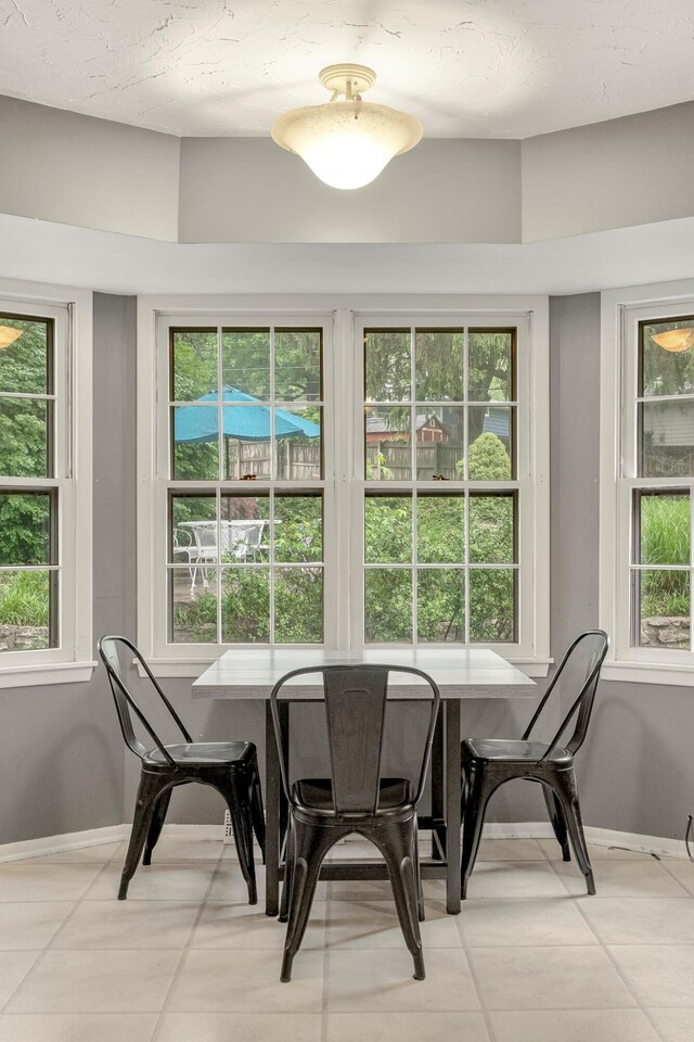 2215 E Rosebrier St, Springfield, MO 65804 - dining room featuring baseboards and light tile patterned floors