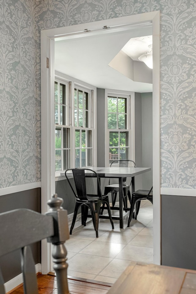 2215 E Rosebrier St, Springfield, MO 65804 - dining room featuring wallpapered walls, wainscoting, and light tile patterned floors