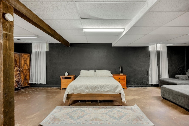 2215 E Rosebrier St, Springfield, MO 65804 - bedroom with finished concrete floors, a textured wall, and a paneled ceiling