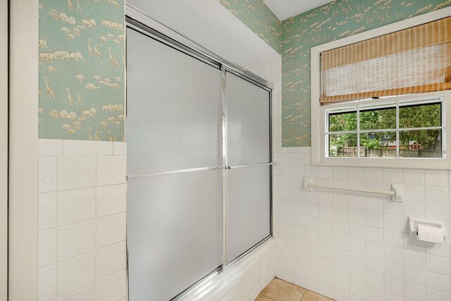2215 E Rosebrier St, Springfield, MO 65804 - bathroom featuring wallpapered walls, wainscoting, tile walls, and tile patterned floors