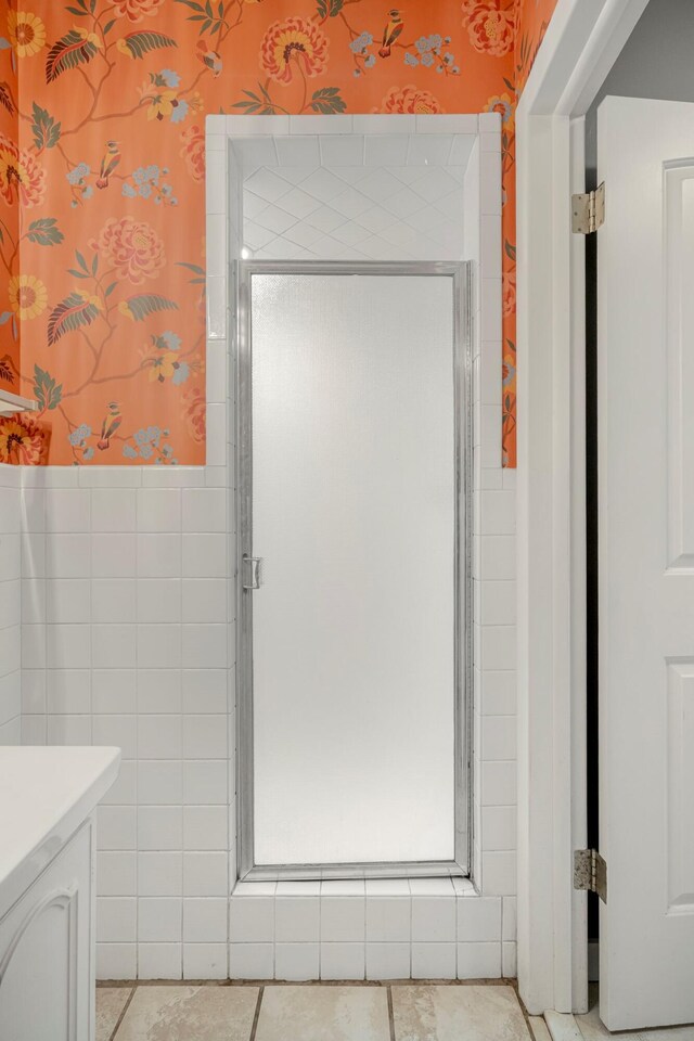 2215 E Rosebrier St, Springfield, MO 65804 - full bath with wallpapered walls, vanity, a shower stall, and tile patterned flooring