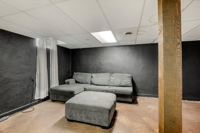 2215 E Rosebrier St, Springfield, MO 65804 - sitting room featuring a textured wall, a paneled ceiling, and unfinished concrete floors