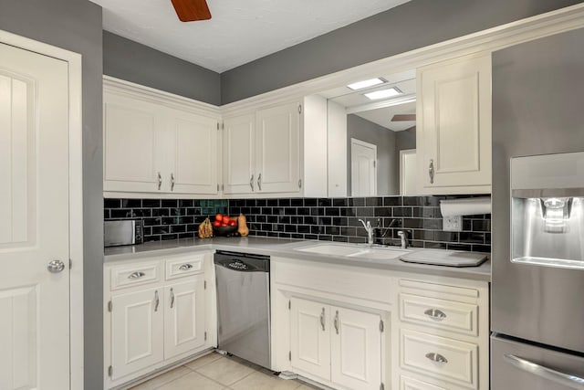 2215 E Rosebrier St, Springfield, MO 65804 - kitchen with stainless steel appliances, light countertops, backsplash, and a ceiling fan