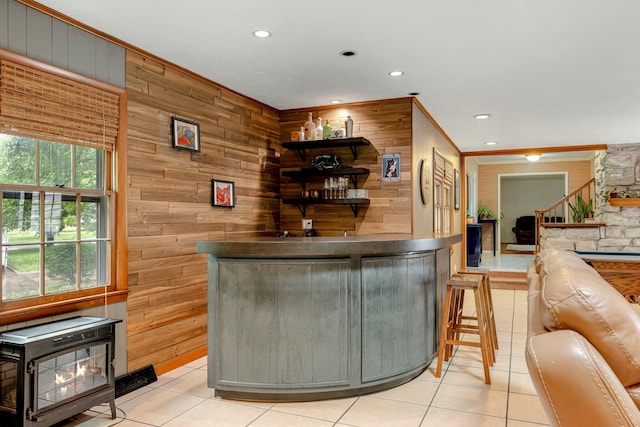2215 E Rosebrier St, Springfield, MO 65804 - indoor dry bar featuring wooden walls, light tile patterned floors, recessed lighting, ornamental molding, and a wood stove