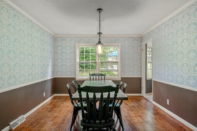 2215 E Rosebrier St, Springfield, MO 65804 - dining space with wood-type flooring, ornamental molding, and a textured ceiling