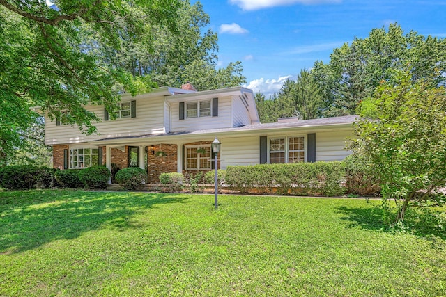 2215 E Rosebrier St, Springfield, MO 65804 - traditional-style house featuring a front yard, brick siding, and a chimney