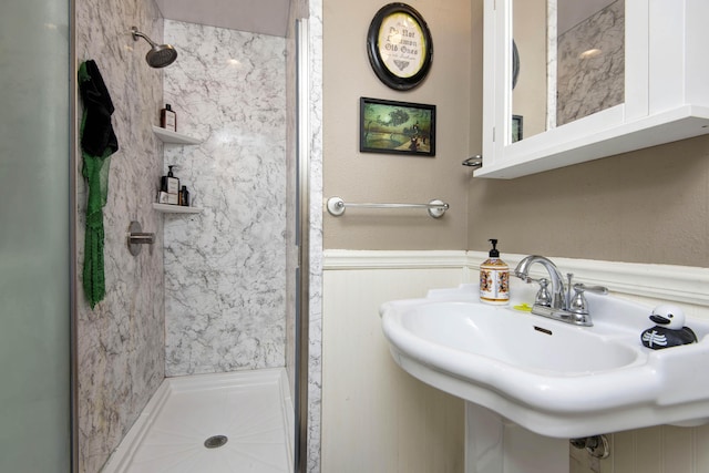 2344 E Manchester St, Springfield, MO 65804 - bathroom featuring a stall shower, a sink, and wainscoting