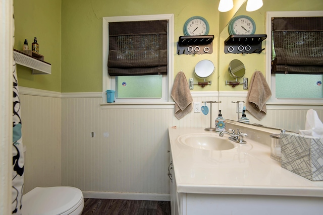 2344 E Manchester St, Springfield, MO 65804 - full bath with wainscoting, wood finished floors, toilet, vanity, and baseboards