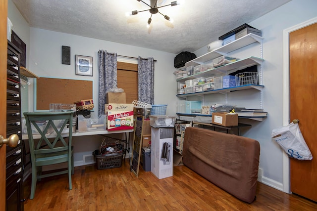 2344 E Manchester St, Springfield, MO 65804 - home office with a textured ceiling, wood finished floors, baseboards, and a chandelier