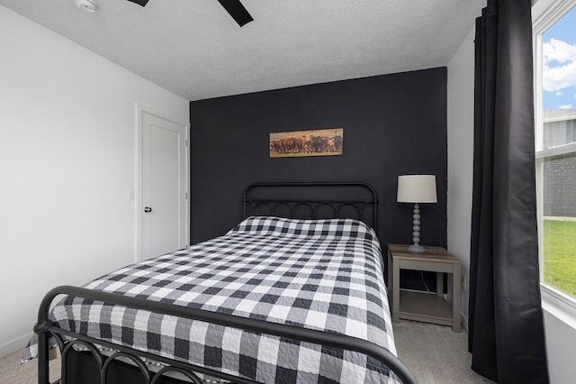 1118 E Lakota St, Nixa, MO 65714 - bedroom featuring carpet floors, multiple windows, baseboards, ceiling fan, and a textured ceiling